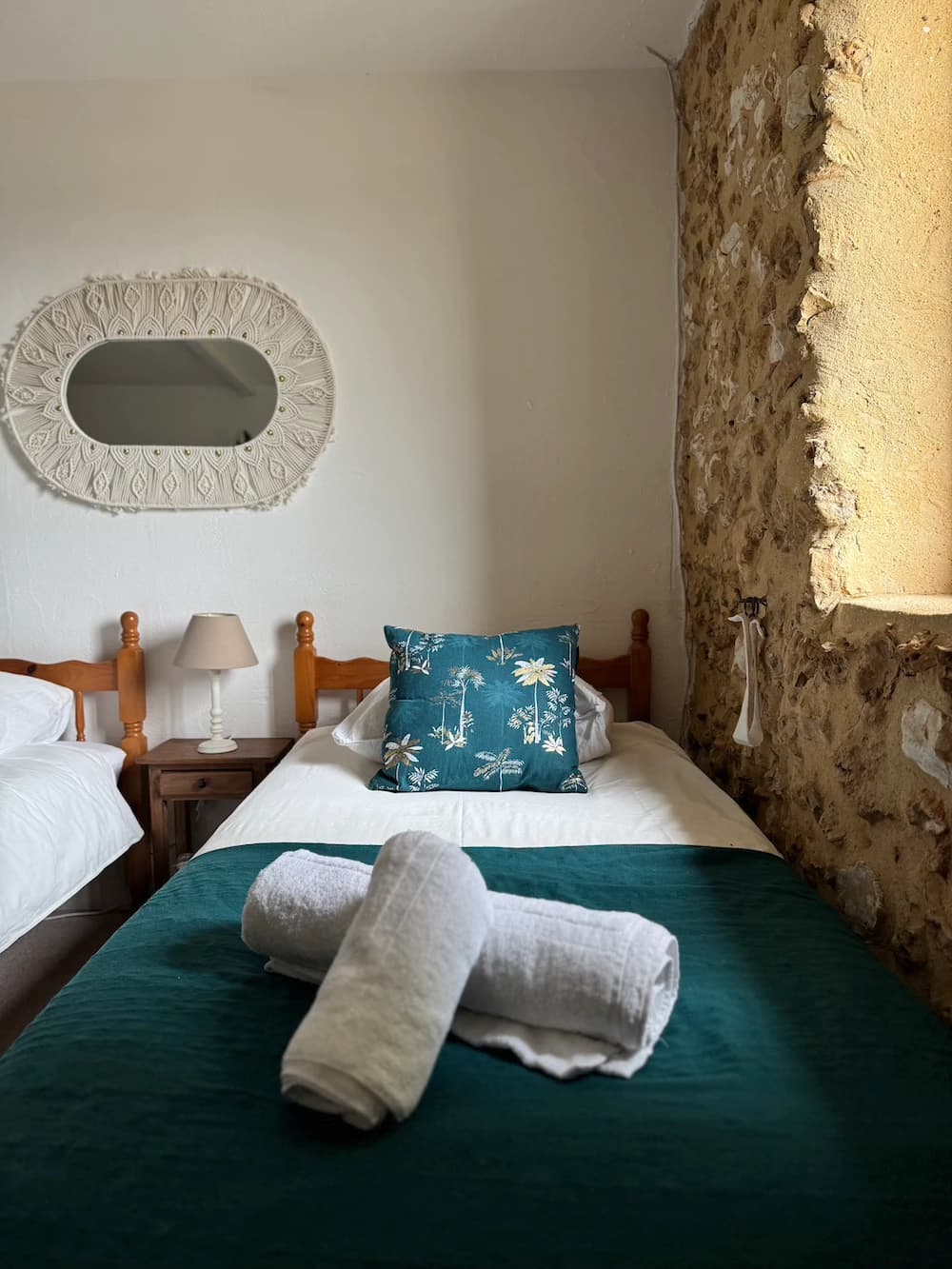 Coussin bleu fleuri sur parure blanche